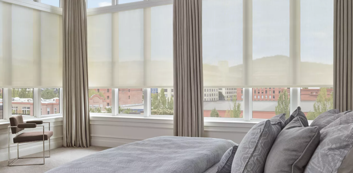 Hunter Douglas Designer Solar Shades covering multiple bedroom windows.