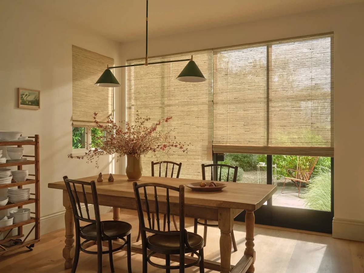 Hunter Douglas Provenance® Woven Wood Shades covering dining room windows.