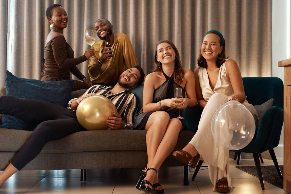 Group of friends celebrating New Year's on a sofa in front of custom drapery