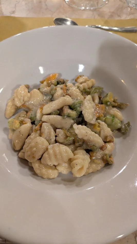 Chiusoni Galluresi pasta with Zucchini Flowers - We made this in our cooking class and it was so stinking good! The pasta is made with just semolina flour and water. The sauce was mostly just pecorino and cracked black pepper. We are definitely makin