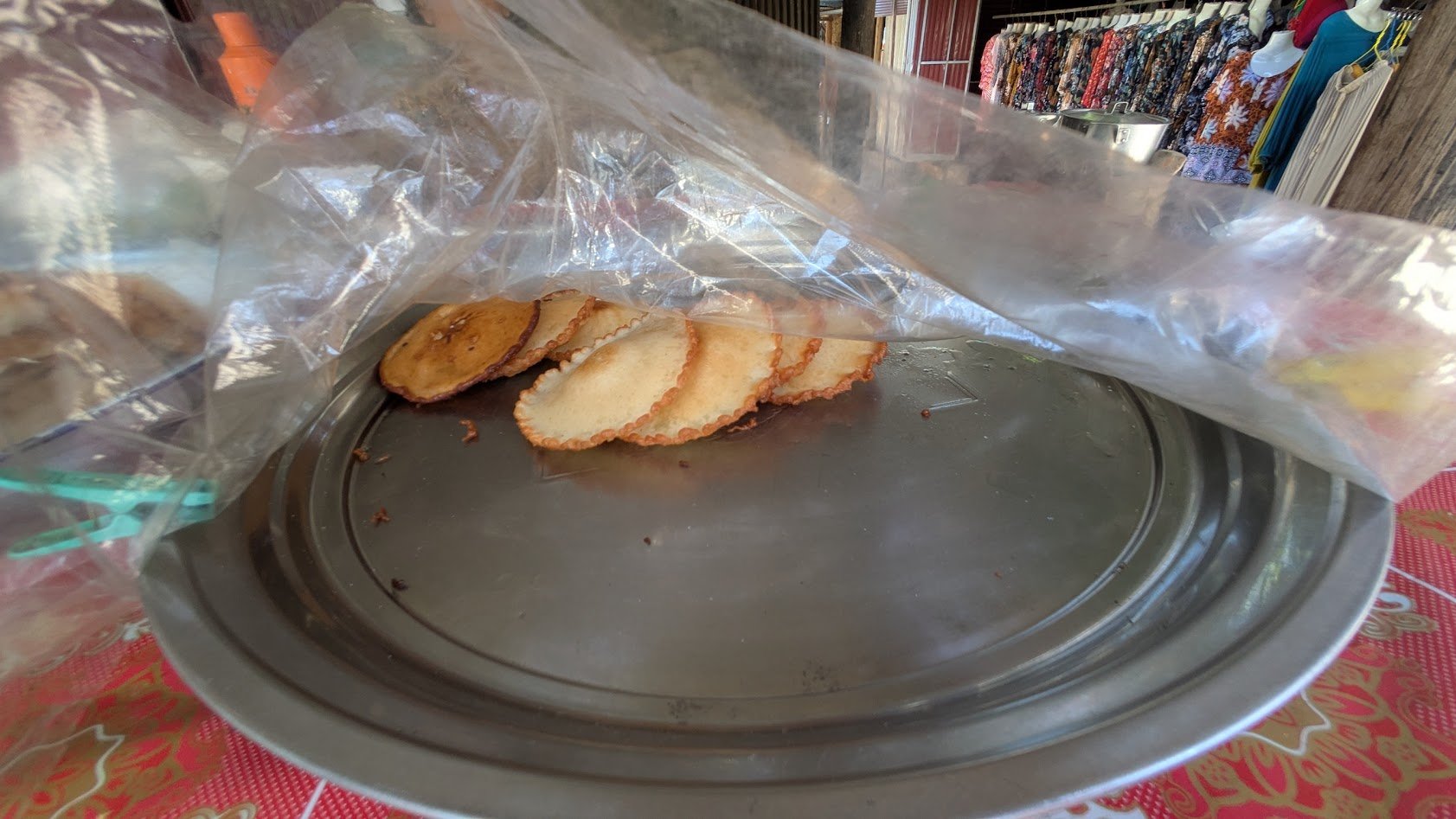 Khanom Fak Bua - a traditional deep-fried sweet made from rice flour, coconut milk, sugar, and pandan juice, resulting in a crispy edge and soft center. They are a street food snack. We had them in a rural village on Kulen mountain. These suckers wer