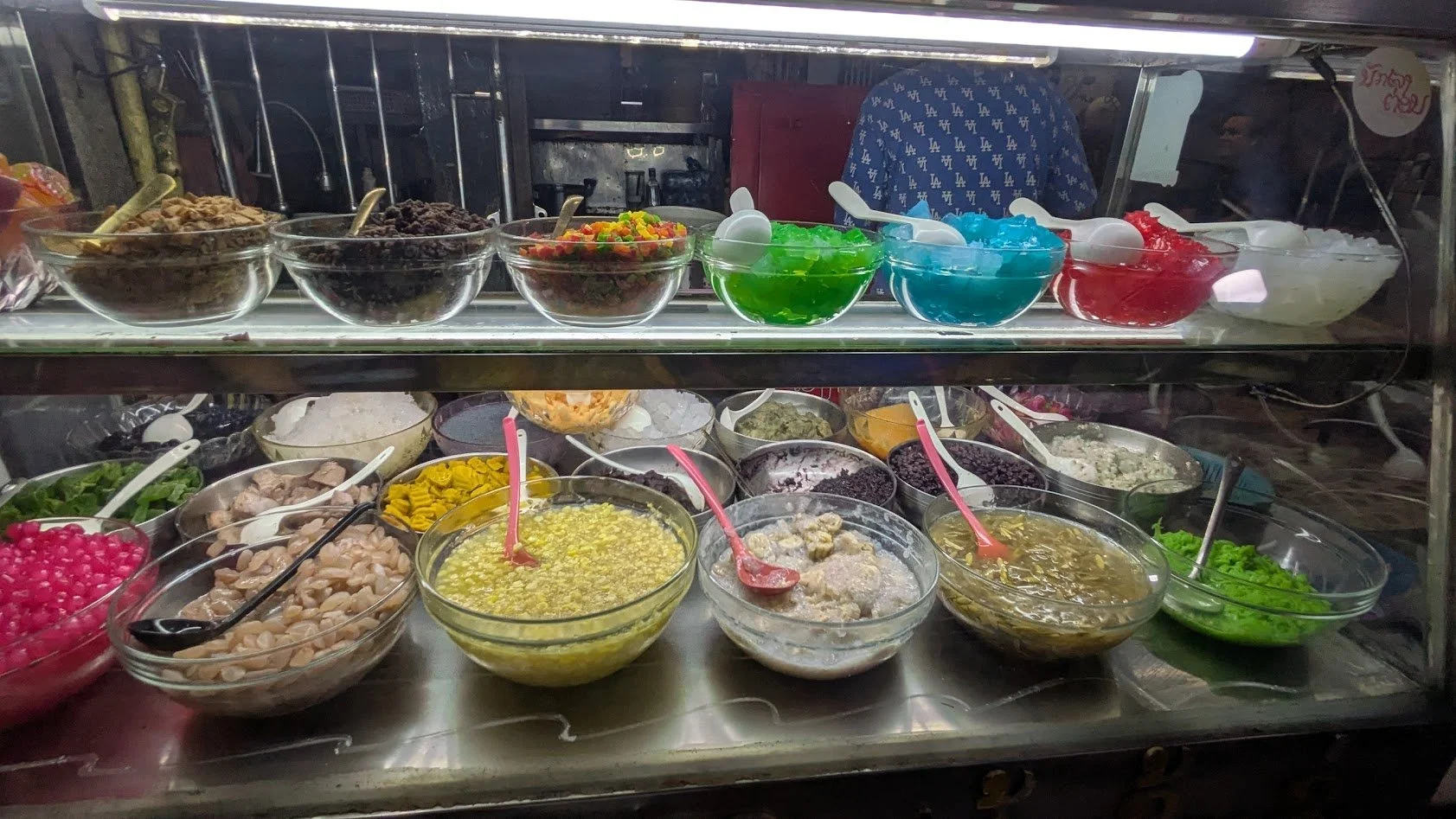 Nam Van - A sweet coconut milk soup with toppings like tapioca pearls, cantaloupe, and jellies served with ice. We had something similar in Vietnam, but what made this place cool was the selection case. They described all the options and you chose an