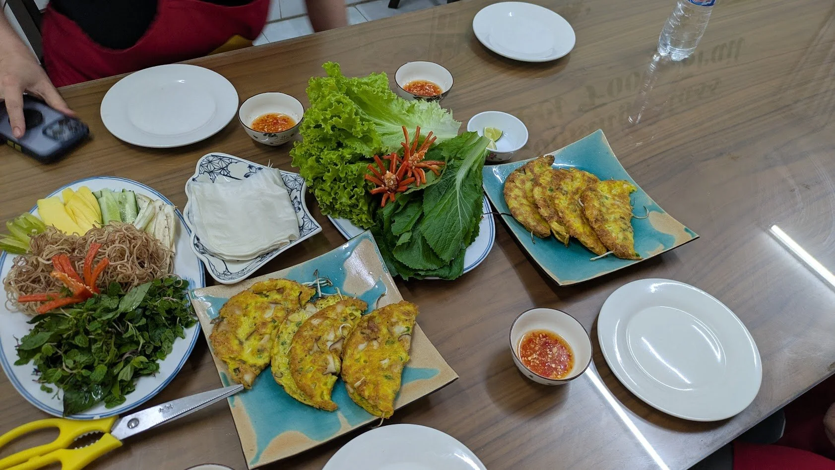 Bánh xèo is a savory, crispy crepe or "sizzling pancake" made from rice flour, water, and turmeric powder (which gives it its yellow color). It's known for its color and "xèo" (sizzling) sound when cooked. It is filled with pork, shrimp, bean sprouts