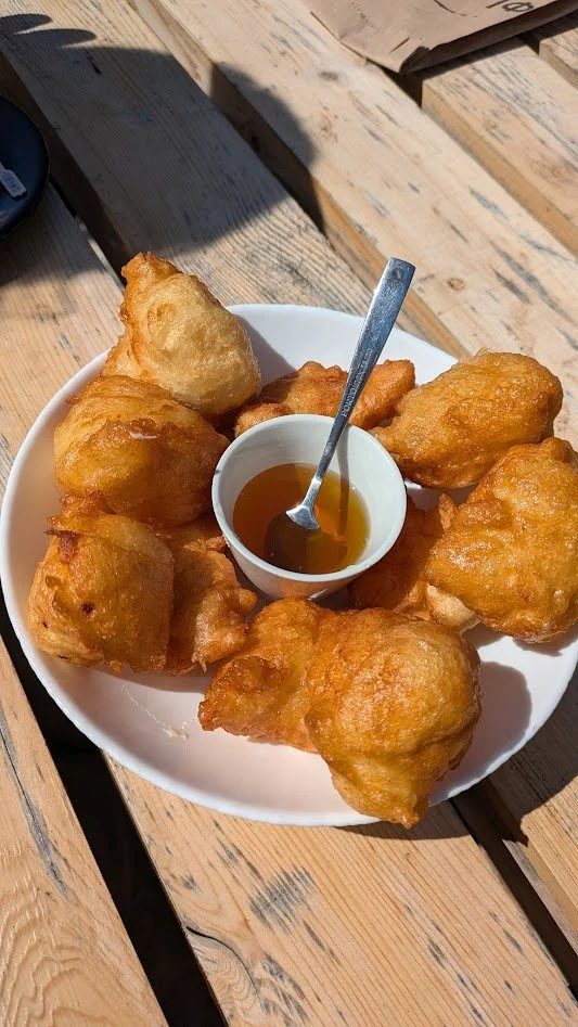 Priganice - a traditional Montenegrin dish of fluffy, deep-fried dough balls, similar to small doughnuts or fritters. Made from a simple batter of flour, water, yeast, and a pinch of salt (so largely flavorless). You dip them in honey, jam, or cheese