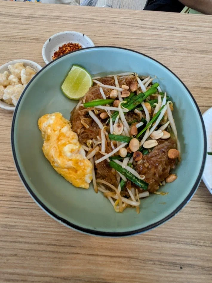 Pad Thai - Arguably the most famous Thai noodle dish.  It is a stir-fried dish  made of thin, flat rice noodles, scrambled egg, bean sprouts, and garlic chives. The distinctive flavor comes from a sauce made with tamarind paste, fish sauce, dried shr