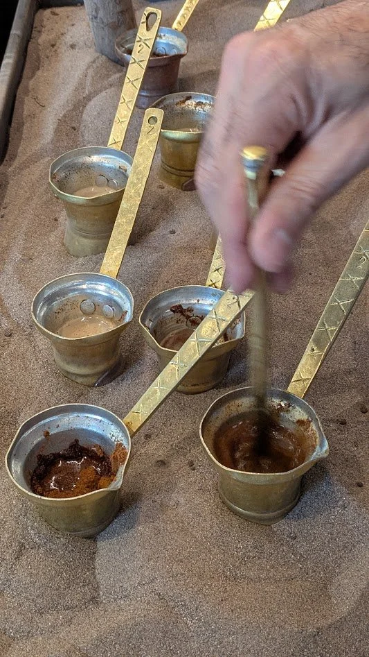 Traditional Greek coffee - It is made by boiling ultra-fine ground coffee beans in a small, long-handled pot (a briki),  and brewed slowly over low heat on hot sand (hovoli). It is served unfiltered with the grounds in small cups, allowing the ground