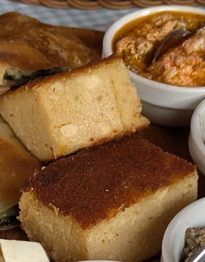 Traditional Albanian cornbread - It is different from American cornbread. The American version is typically sweet, cakelike, and functions as a side dish.  The Albanian variety is very dense/heavy and savory (not at all sweet) and there are bits of f