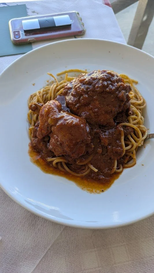 Pastitsada - a slow-cooked cockerel (young male chicken) stew, from the island of Corfu. It is cooked in a spicy red tomato sauce and  served over pasta. Darren had it... I think he liked it.