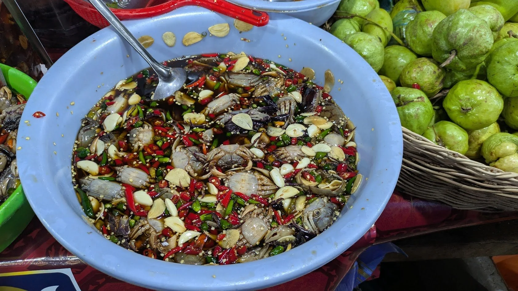 Spicy and sour tiny crabs - a popular snack  featuring small, edible crabs marinated in a savory, tangy, and spicy sauce. We did not eat these! We saw them in the market.
