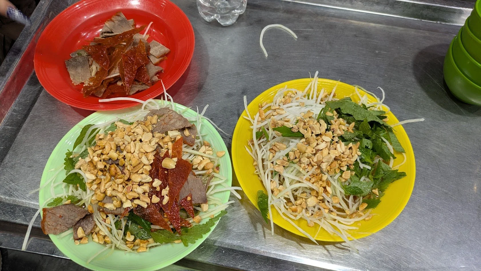 Nộm thịt bò khô is a popular Vietnamese street food salad from Hanoi, featuring dried beef jerky mixed with crunchy shredded green papaya, herbs, and a savory-sweet dressing. We had it on our food tour in Hanoi. I think we all liked it! 