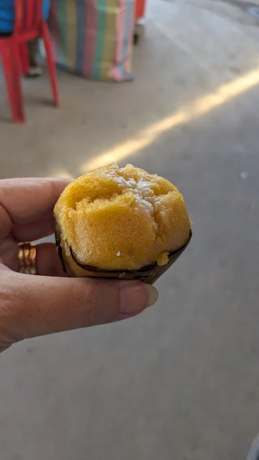 Palm cake - a traditional dessert made from ripe toddy palm fruit, rice flour, coconut milk, and sugar. steamed in banana leaf cups. They are a soft, fluffy little cake, sometimes topped with grated coconut. We LOVED these things!