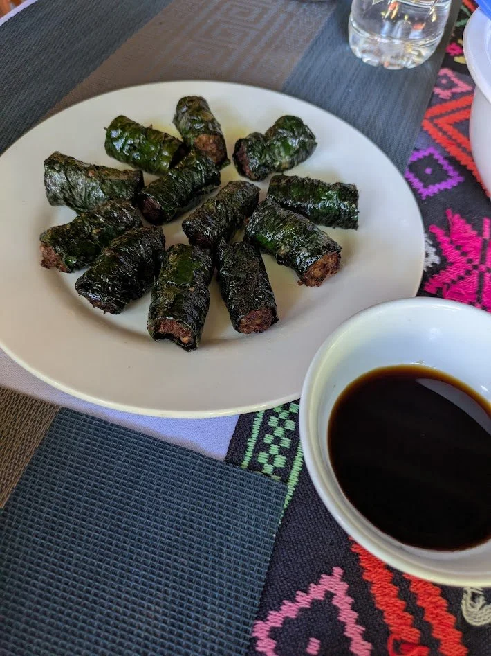 Bò lá lốt is a popular Southern Vietnamese dish featuring minced beef mixed with garlic, shallots, and spices, wrapped lolot leaves and grilled over charcoal. There wasn't a vegetarian version for me, but Grady thought they were pretty good. 