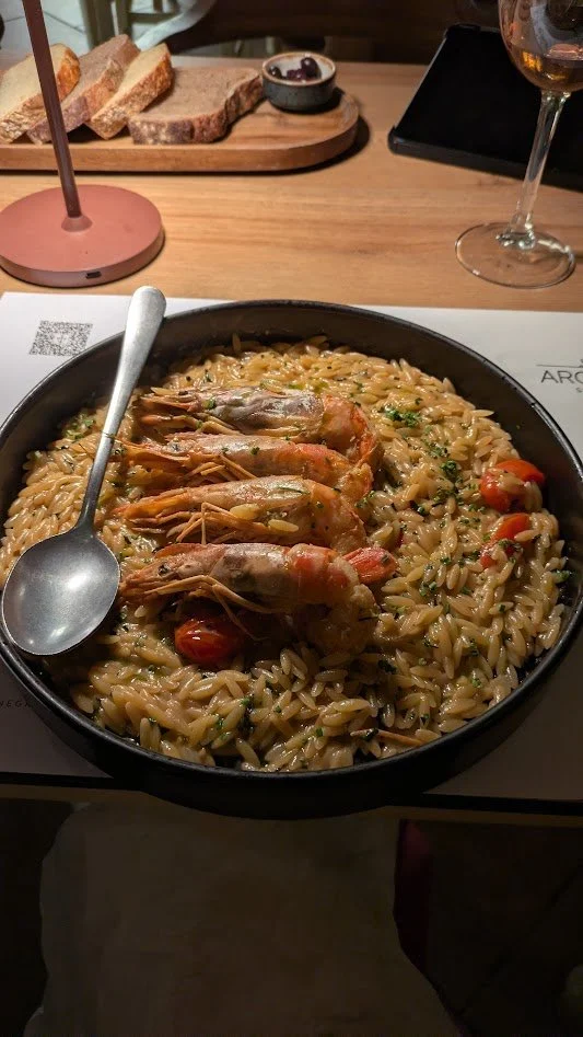 Kritharoto me garides - one-pot comfort food of orzo cooked in a creamy, tomato-based broth with shrimp, often flavored with ouzo and herbs. Shrimp heads are often used to make the stock. It was really good!