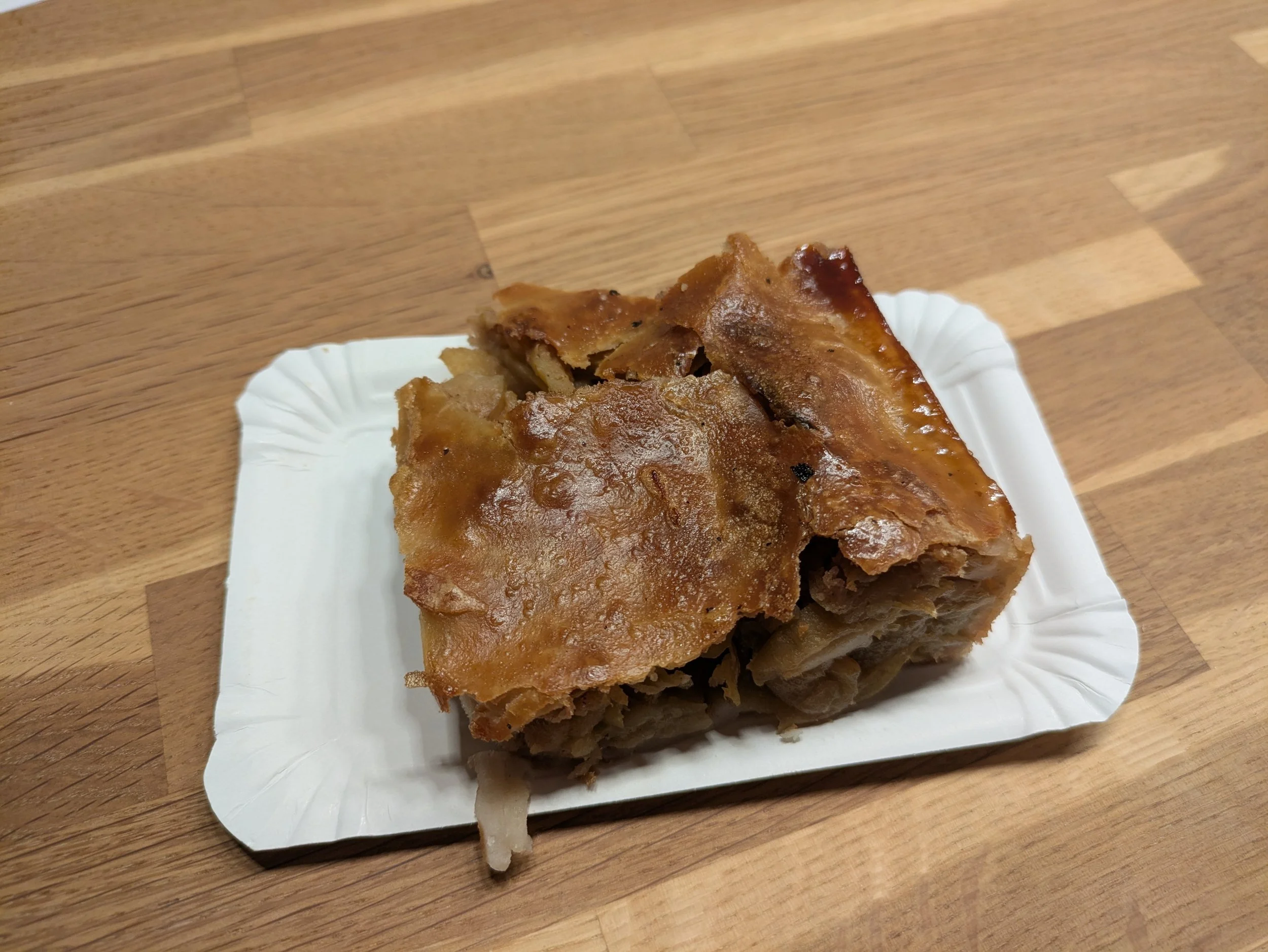 Austrian Apfelstrudel is a dessert made from layers of very thin, unleavened pastry and a filling of spiced, sweet apples with raisins and breadcrumbs to absorb excess moisture.