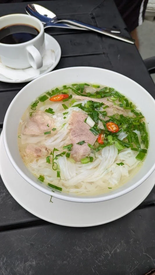 Phở (pronounced Phu - if you say it wrong, you are ordering up a prostitute!). It is a traditional Vietnamese noodle soup consisting of a slow-simmered broth, flat rice noodles, herbs, and meat. Then you add whatever you want to spice it up (lime, ch