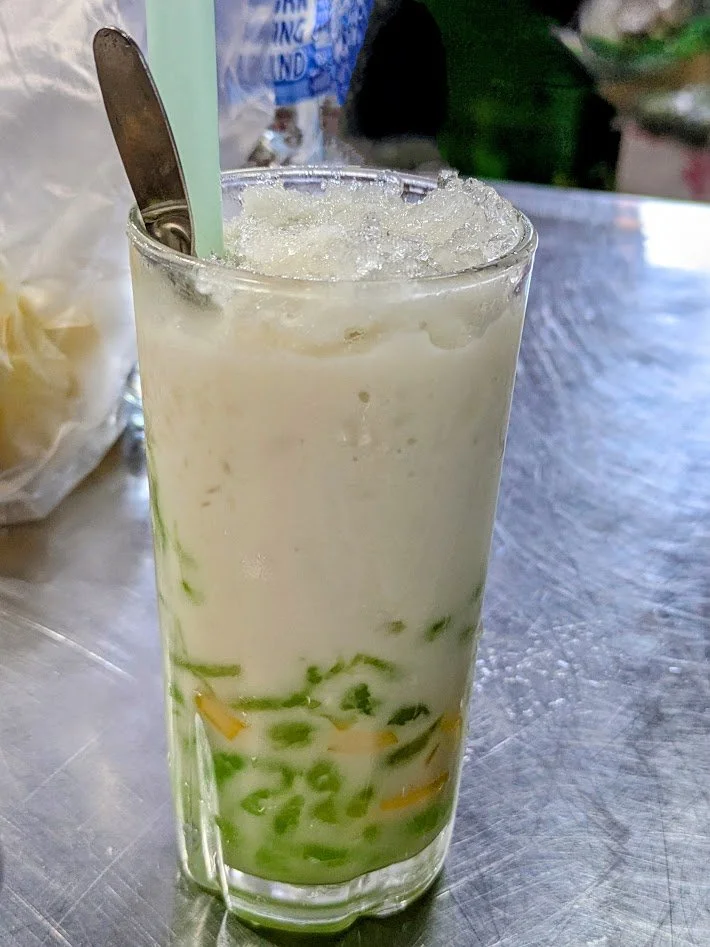Lod Chong bubble tea - a Thai dessert drink made with green rice flour jelly noodles, sweet coconut milk, coconut water, and palm sugar syrup. You drink it through a fat straw and the noodles come through the straw in little chunks almost like tapioc