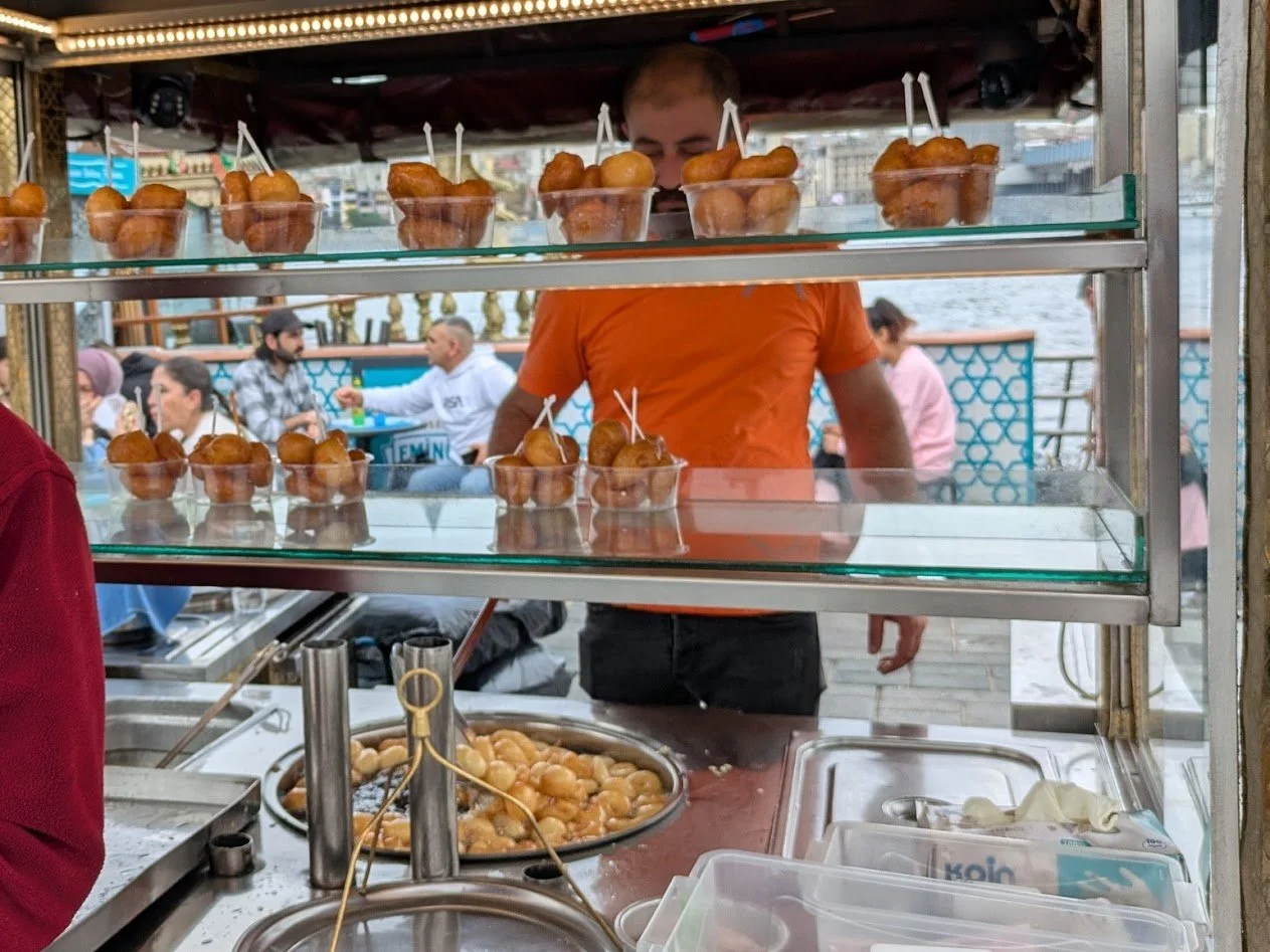 Osmanlı lokması - they're basically little donuts cooked and sold by street side vendors. It's a popular Turkish sweet made of fried, yeast-leavened dough balls that are soaked in a sweet syrup (or you can have salty). Grady had some and said they we