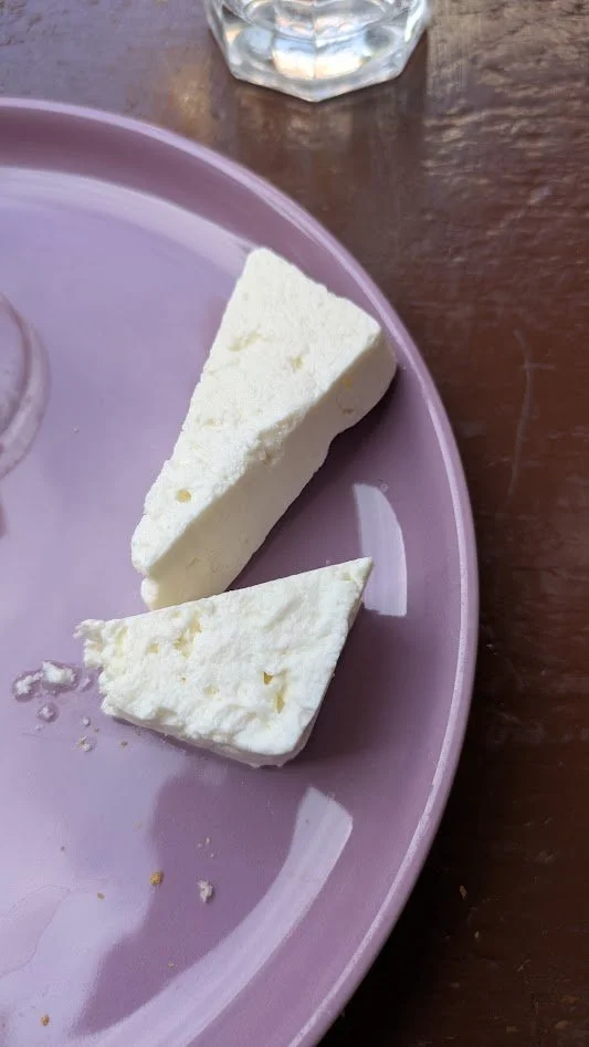 Sirene - which literally translates "white cheese". It is a crumbly, brined cheese with a bold, salty, and tangy flavor. It's NASTY!