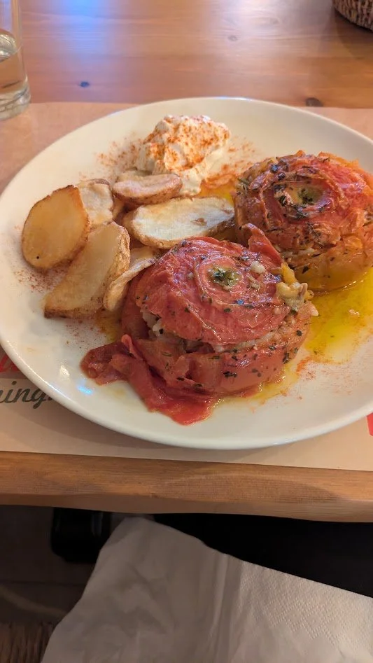 Gemista - a classic Greek dish of "stuffed"  tomatoes filled with a mixture of rice, herbs, and olive oil, then baked until tender. It is a quintessential vegetarian Mediterranean dish. Really good!