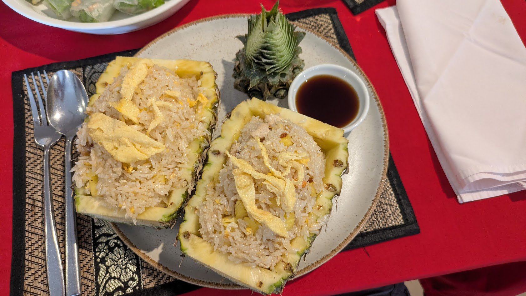 Pineapple fried rice - fried rice with pineapple chunks and some type of meat (chicken in this case) served in a hollowed out pineapple.