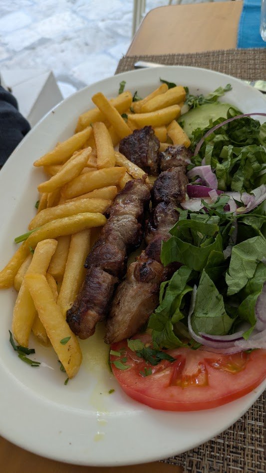 Lamb souvlaki - basically it is lamb kebobs. It's a popular Greek food consisting of small, marinated chunks of lamb threaded onto skewers and grilled over charcoal. It is marinated in olive oil, lemon juice, garlic, and oregano. Per Darren, it was g
