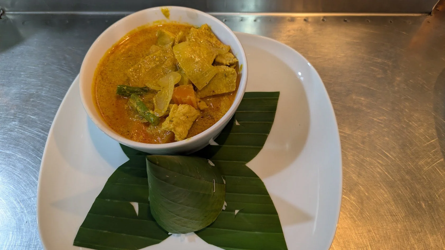 Kari Sach Moan - a popular traditional Cambodian chicken curry dish made with vegetables and a coconut milk-based sauce seasoned with  turmeric, lemongrass, and kroeung paste. It is a quintessential, soul-warming staple in Khmer cuisine. Grady made i