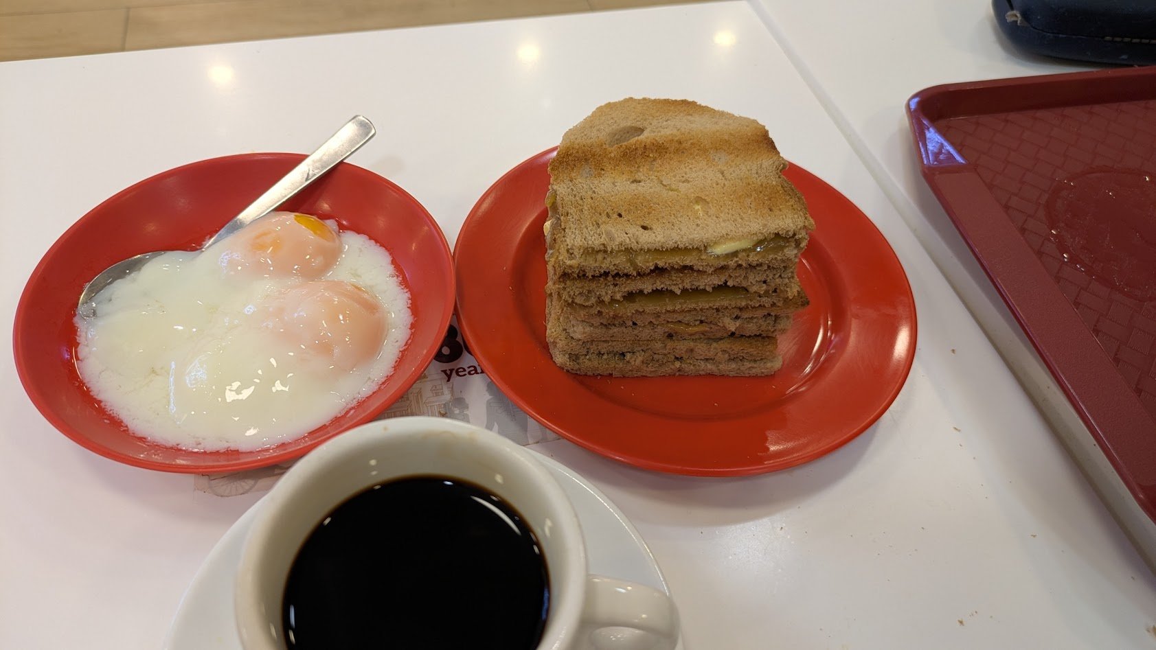 Kaya toast - an iconic Singaporean breakfast  of toast layered with coconut jam (kaya) and thick slices of cold butter. Primarily served with soft-boiled eggs and hot coffee (kopi). I thought it tasted like toast with butter and brown sugar. It was t