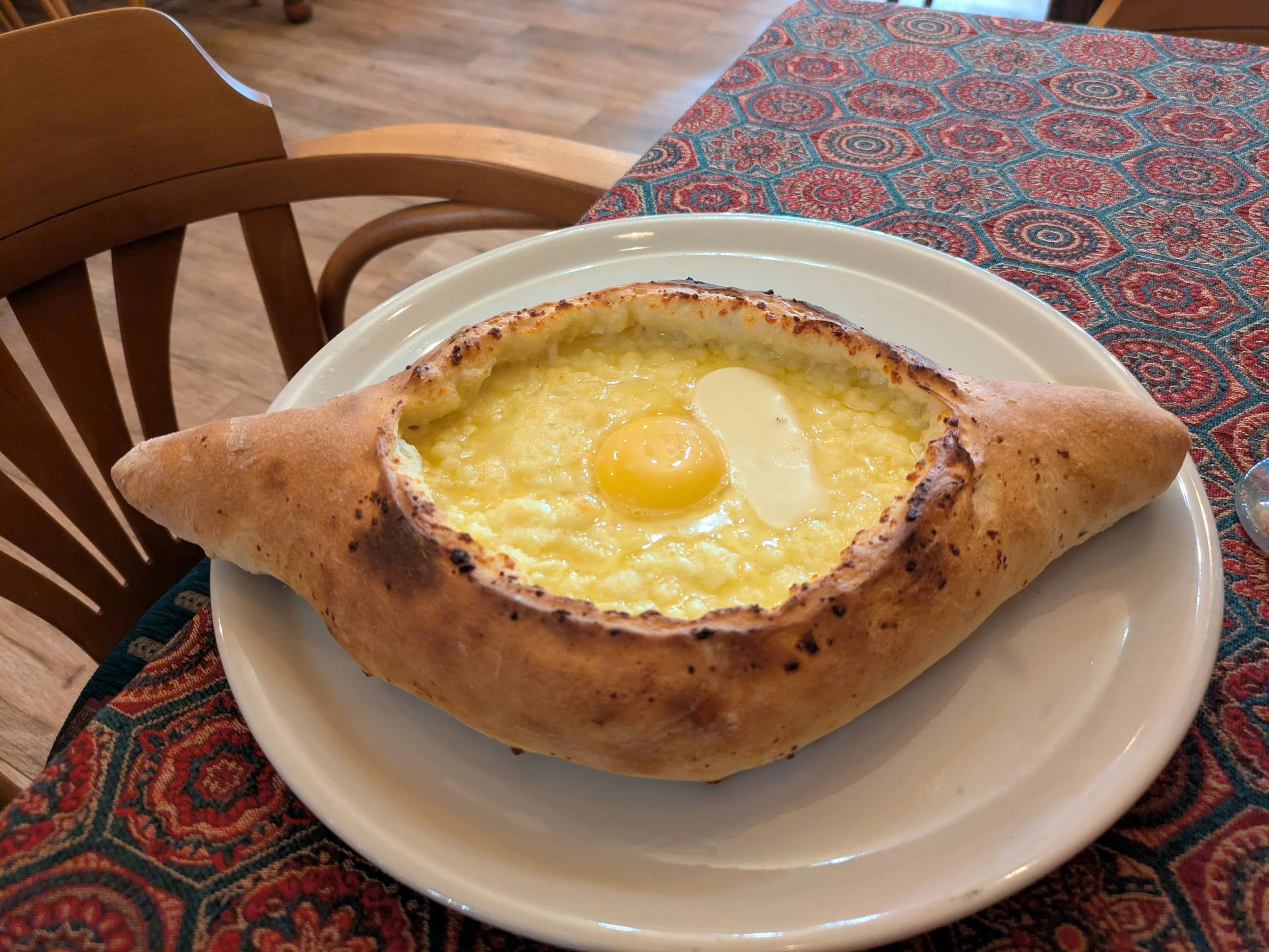 Khachapuri Adjaruli – The best description I found was “a molten canoe of carbohydrates and dairy”! It is a “boat” of traditional Georgian bread filled with sulguni cheese and baked. When it is removed from the oven, they add hunks of butter and an e