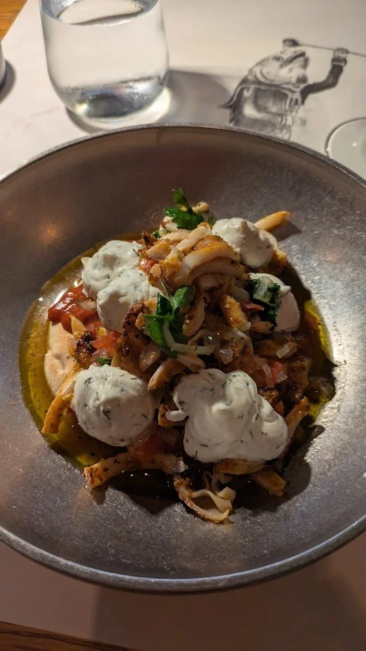 Calamari gyros - grilled calamari rings with grilled vegetables, warm pita bread and tzatziki sauce. This dish is a popular, lighter Mediterranean alternative to traditional meat gyros. It was pretty good.