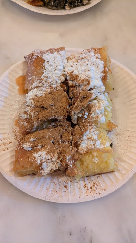 Bougatsa - a traditional Greek breakfast pastry or dessert originating from Thessaloniki, consisting of crispy, buttered phyllo dough wrapped around a sweet semolina custard, served warm with powdered sugar and cinnamon. I could eat this every day!! 