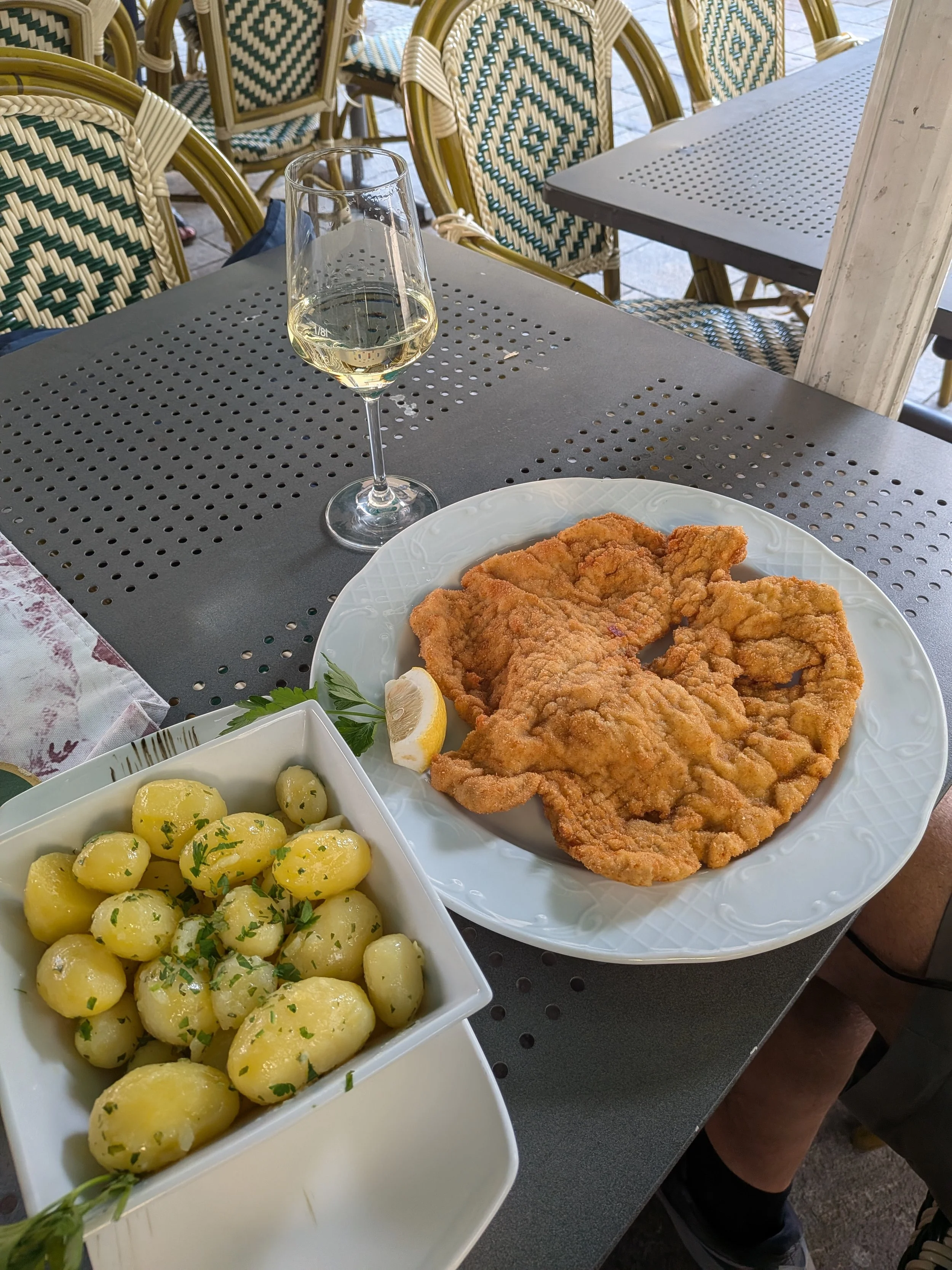 Wiener Schnitzel, the traditional Austrian dish made from thinly pounded, breaded, and pan-fried veal, and often served with a lemon slice and parsley potatoes.