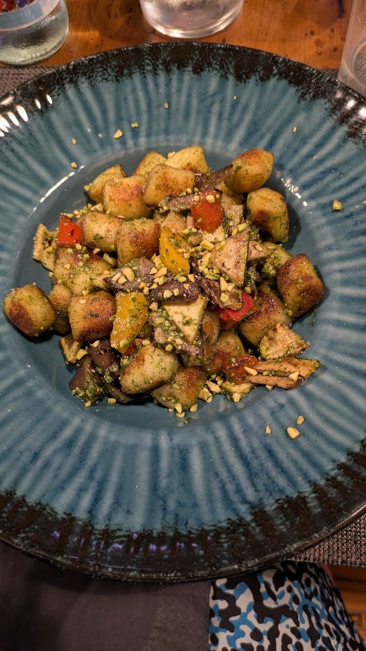 Gnocchi - .  Potato-based variations of pasta which originated in northern Italy where potatoes thrived, making them a cheap and filling staple for peasants when grain was scarce. Mine was made with vegetables and some kind of light olive oil based s