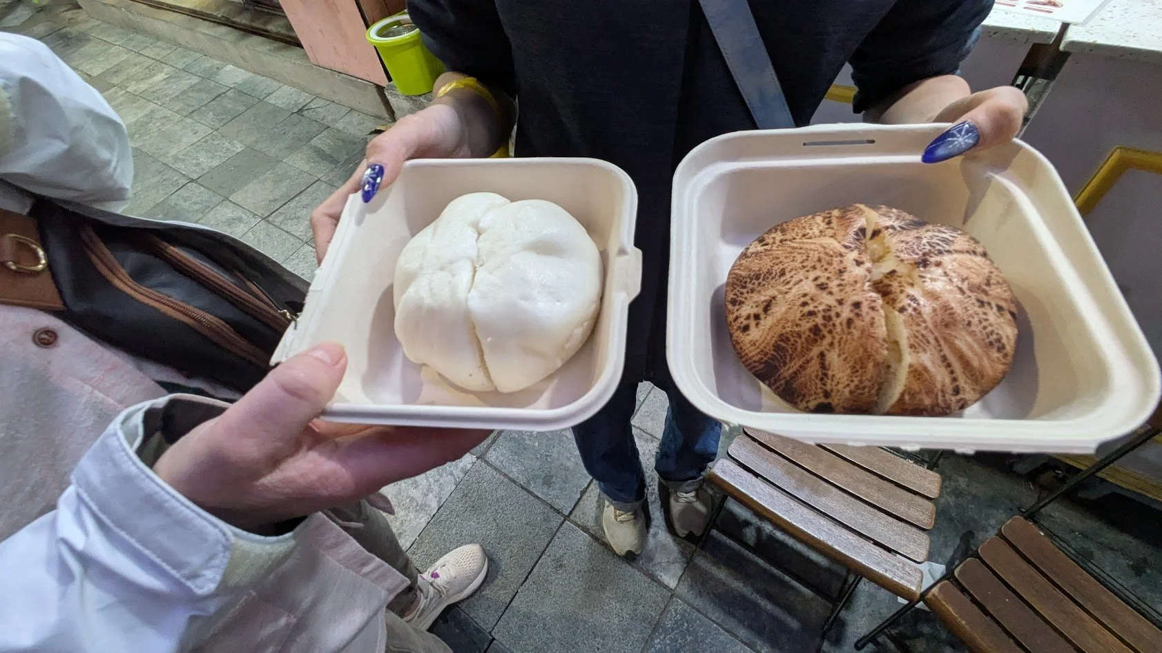 Bánh bao is a steamed bun that is a fluffy, slightly sweet white bread filled with a mixture of minced pork, onions, and mushrooms. It's a common snack or breakfast item.  We tried it on a food tour in Hanoi. It was pretty good, but we were so full a