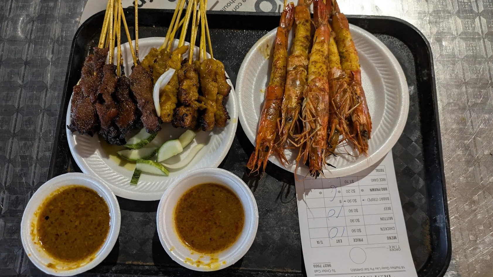 Satay -  a beloved hawker dish of marinated, skewered meat grilled over a charcoal fire and served with a thick, savory-sweet peanut sauce. You order it by the "set". Our "set" consisted of 10 chicken, 10 beef, and 6 BBQ prawn skewers. It was SO deli