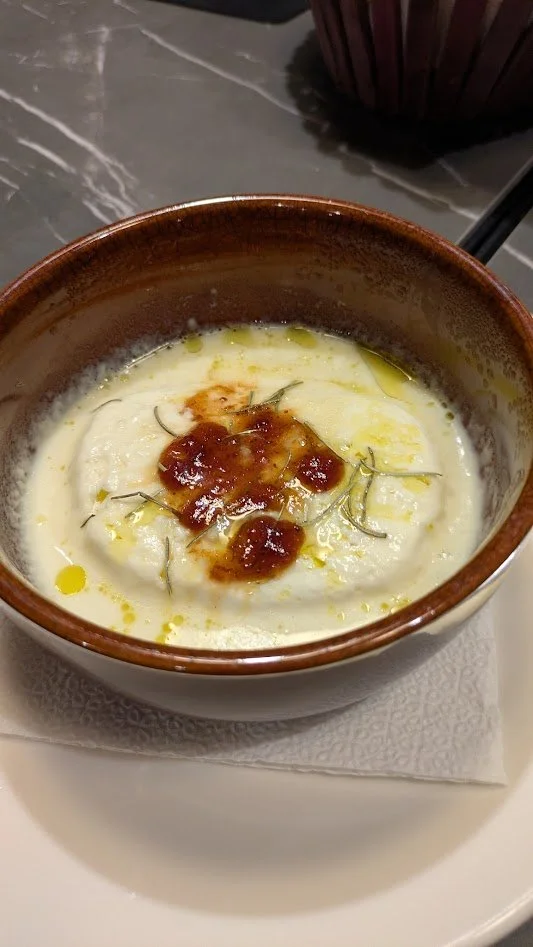 Grilled kashkaval cheese - a hot dish made from kashkaval, a semi-hard, yellow sheep's or cow's milk cheese native to Albania.  It has a savory, nutty flavor. When grilled, it holds its shape - the inside melts and the outside develops a golden crust