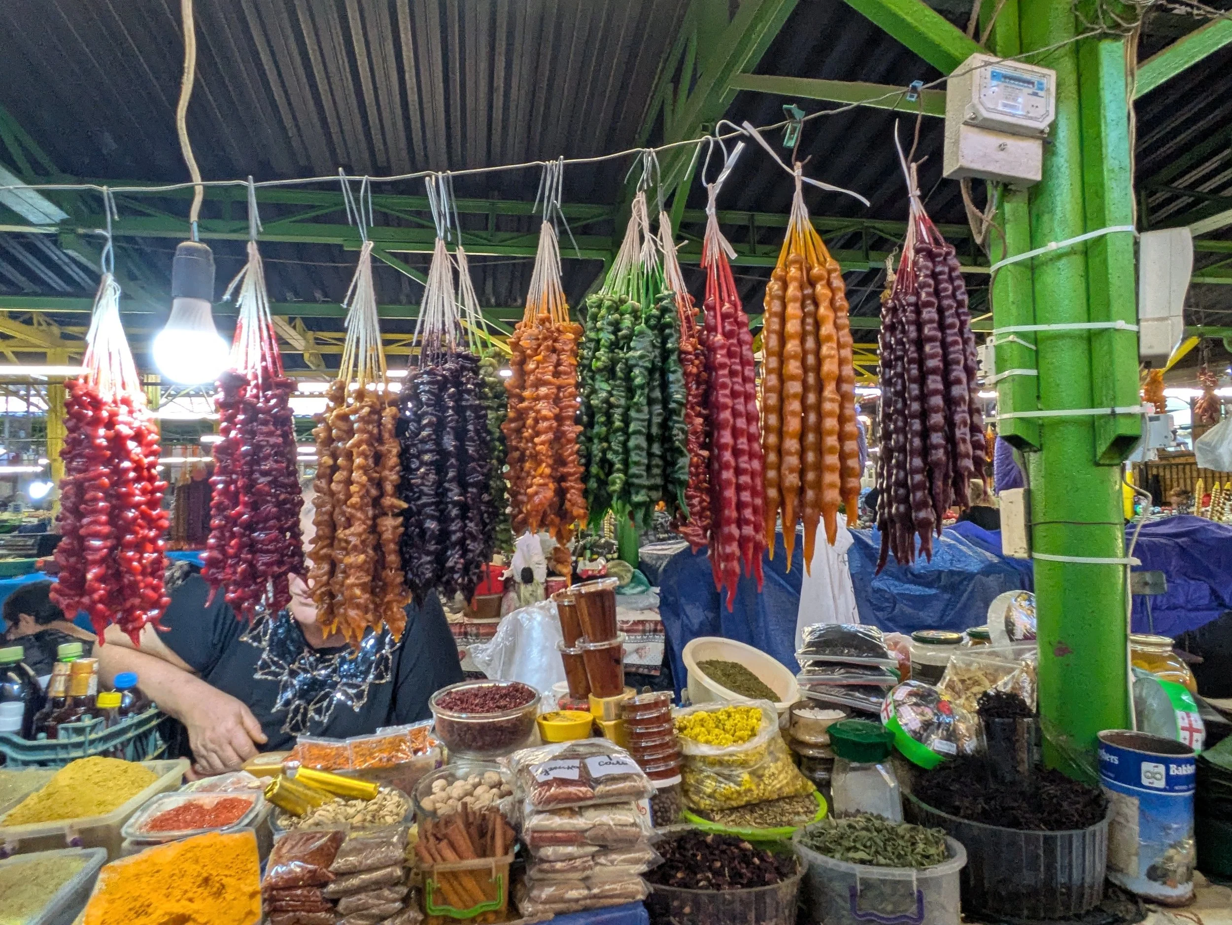 Churchkhela - Lumpy, colorful confections found hanging in markets. Concentrated grape juice (left over from the wine harvest) is poured repeatedly over strands of walnuts. Each layer is left to dry until a chewy, waxy exterior envelops the nuts. It