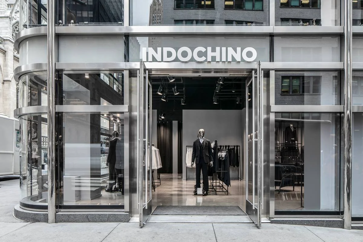 Indochino's curved glass storefront and illuminated signage on Madison Avenue in New York City