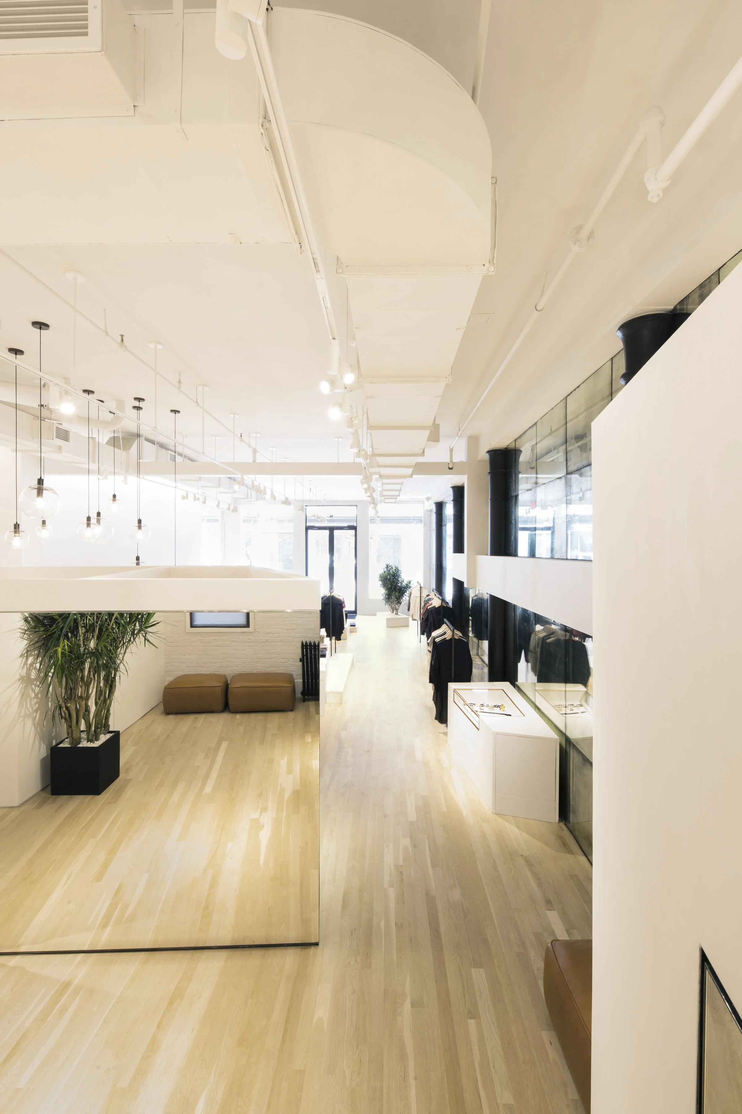 Maiyet boutique interior with hanging pendant lights and warm wood flooring