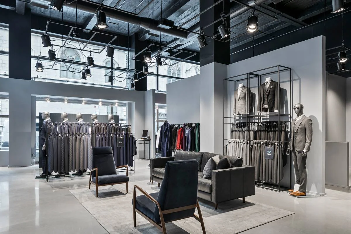 Made-to-measure suit displays and lounge seating inside Indochino's Madison Avenue store