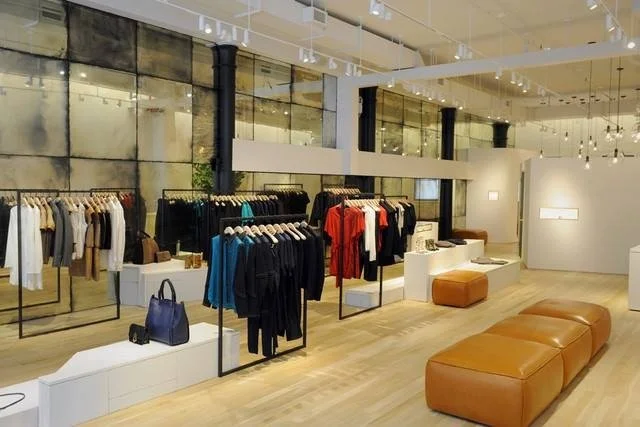 Colorful clothing displays against an antique mirrored wall in the Maiyet store