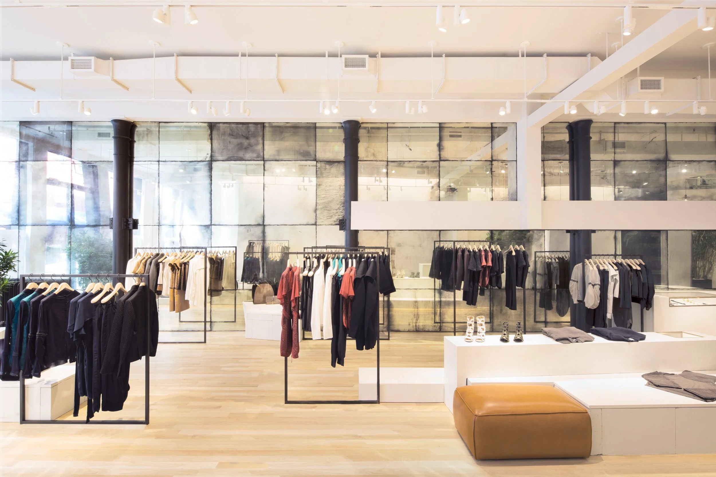 Antique mirrored wall backdrop with clothing racks in Maiyet's SoHo store