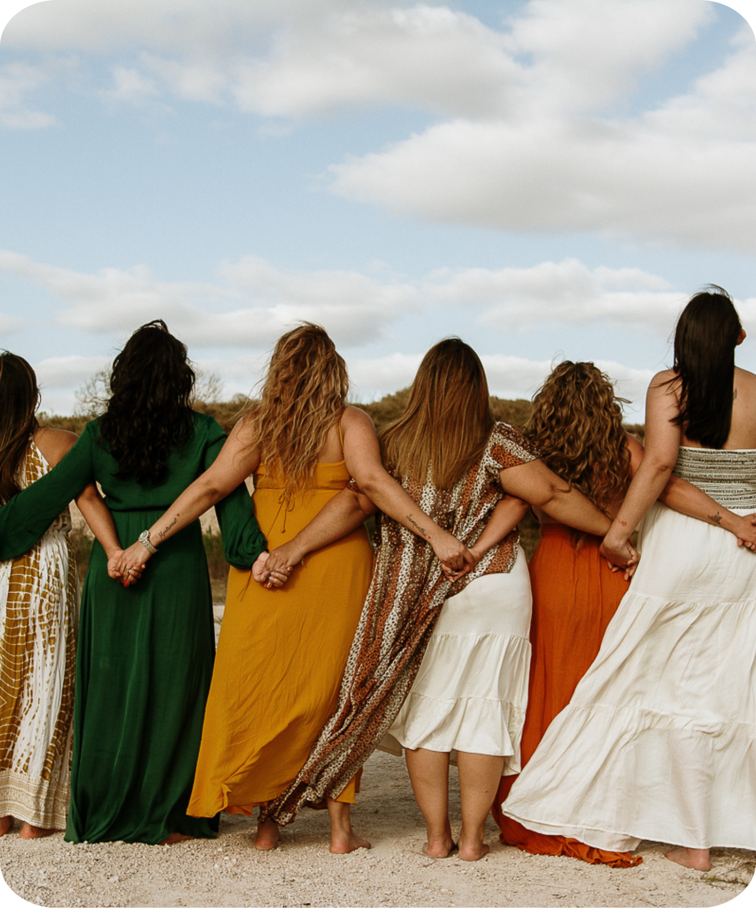 Women standing together at sunset celebrating connection and travel in South Africa