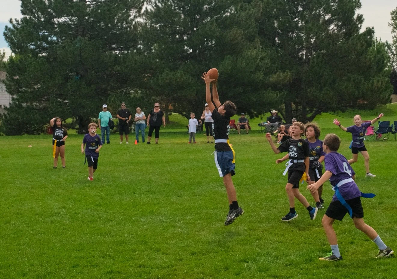 BestPlay Sports 11 to 13 year old boy catching a ball during the flag football league in Broomfield/Westminster, Colorado