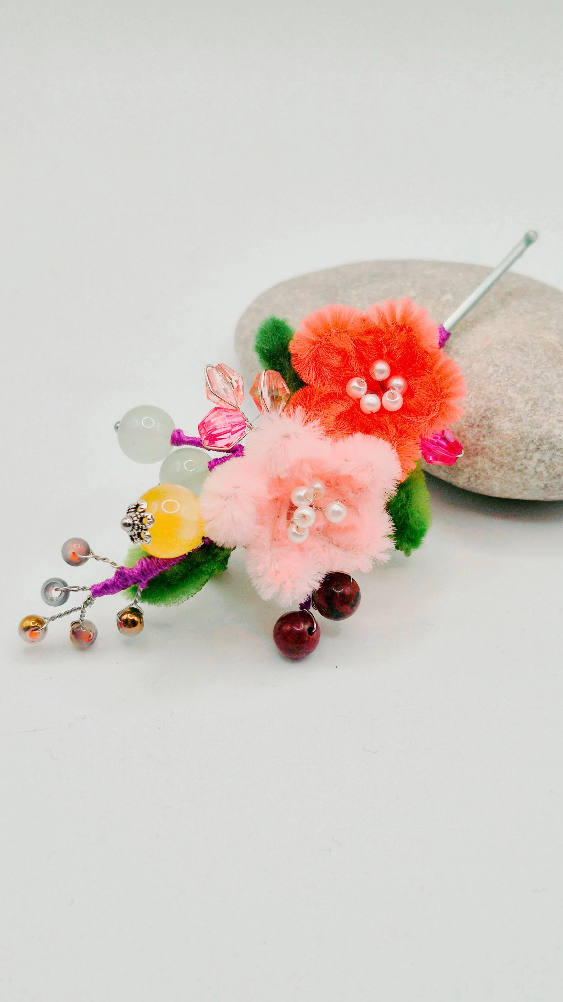 Closeup of a silkflower fuzzy sakura cherry blossom bobby pin set of two with pink and peach flowers, featuring various stone beads