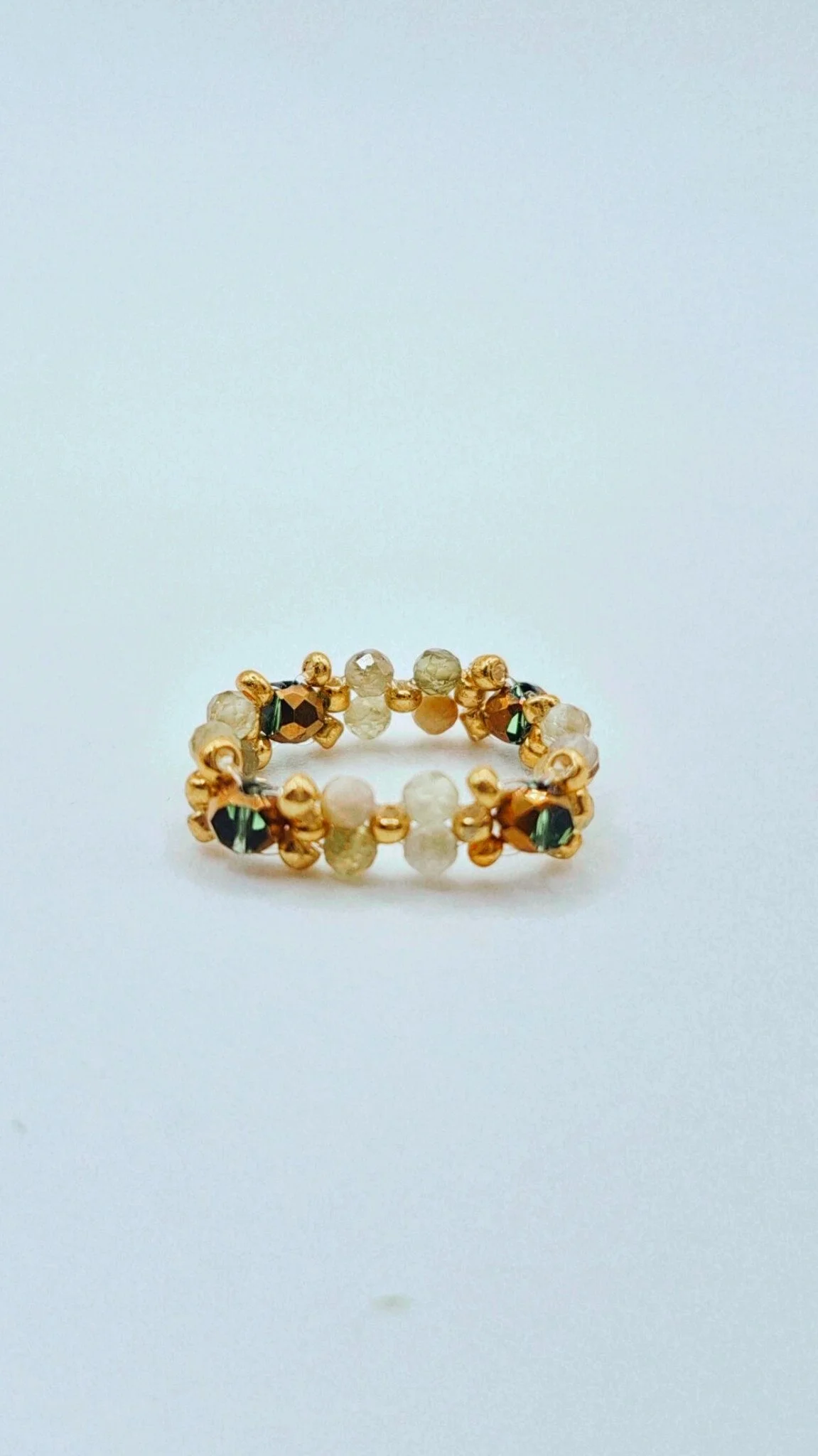 a small beaded ring with natural gemstone and gold-edged glass beads