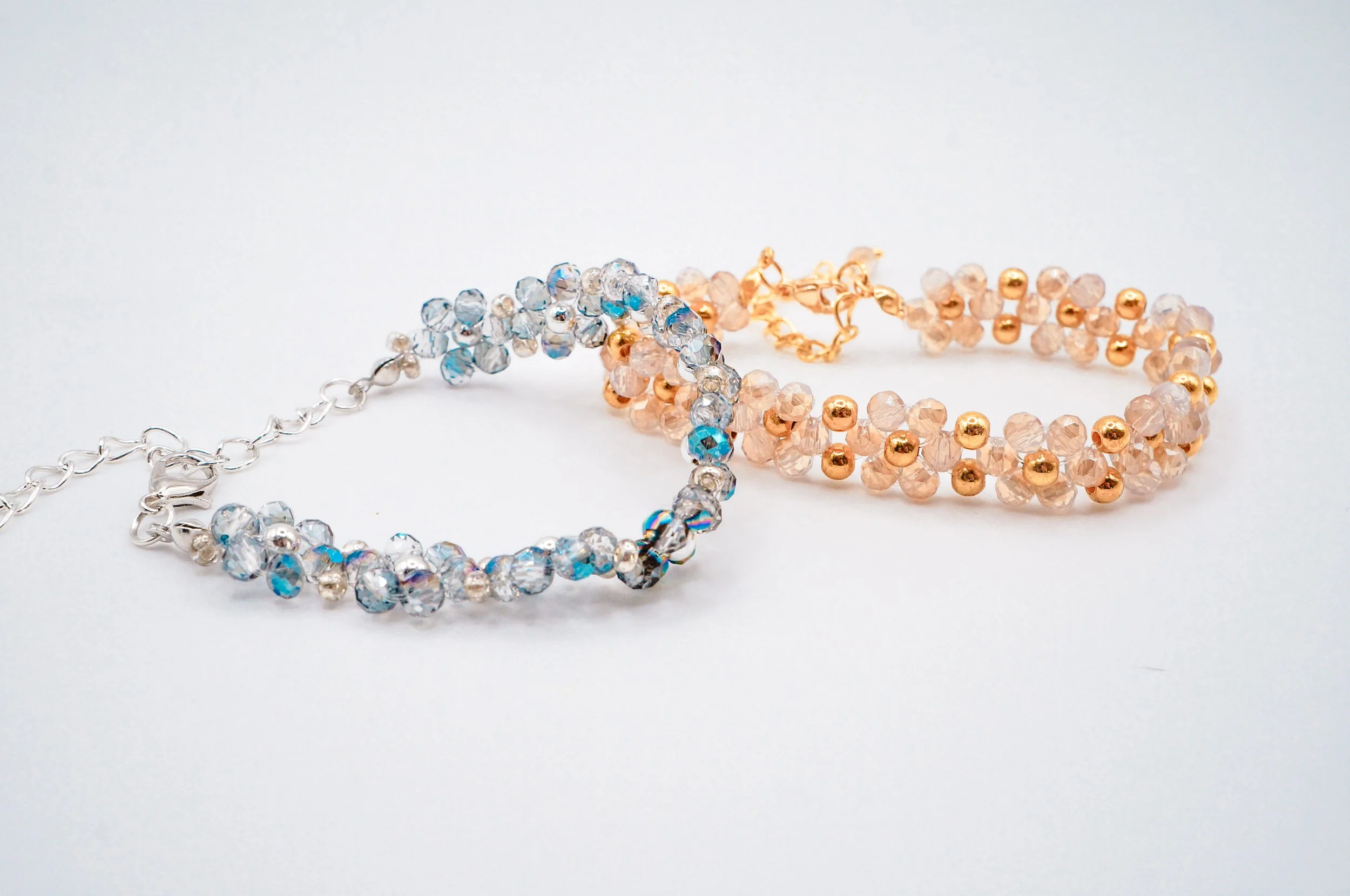 A set of glittering hand-beaded bracelets for formal dress occassions with gold and silver holographic beads and high quality metal beads