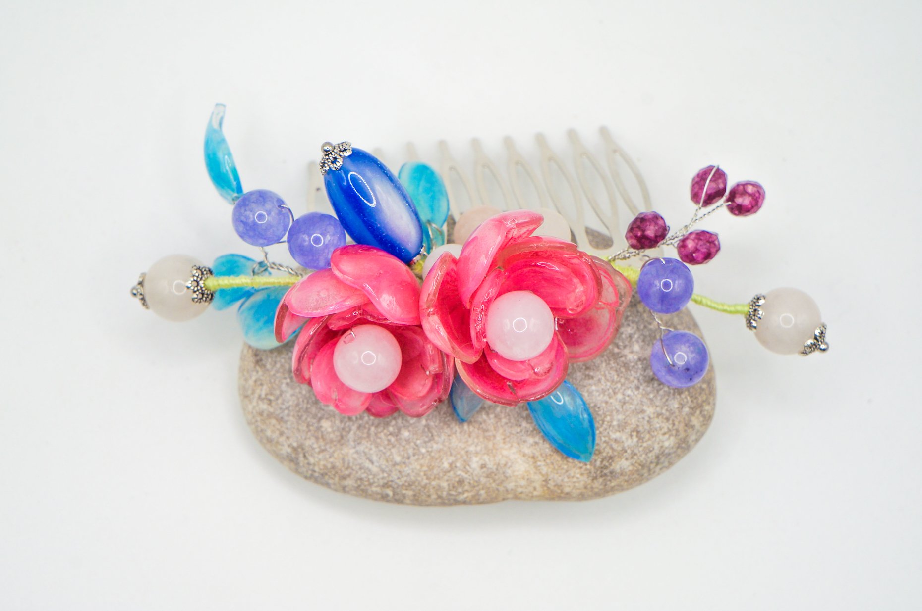 top view of a large handmade silver hair barette/comb featuring pink peony and sky blue leaves with various gemstones