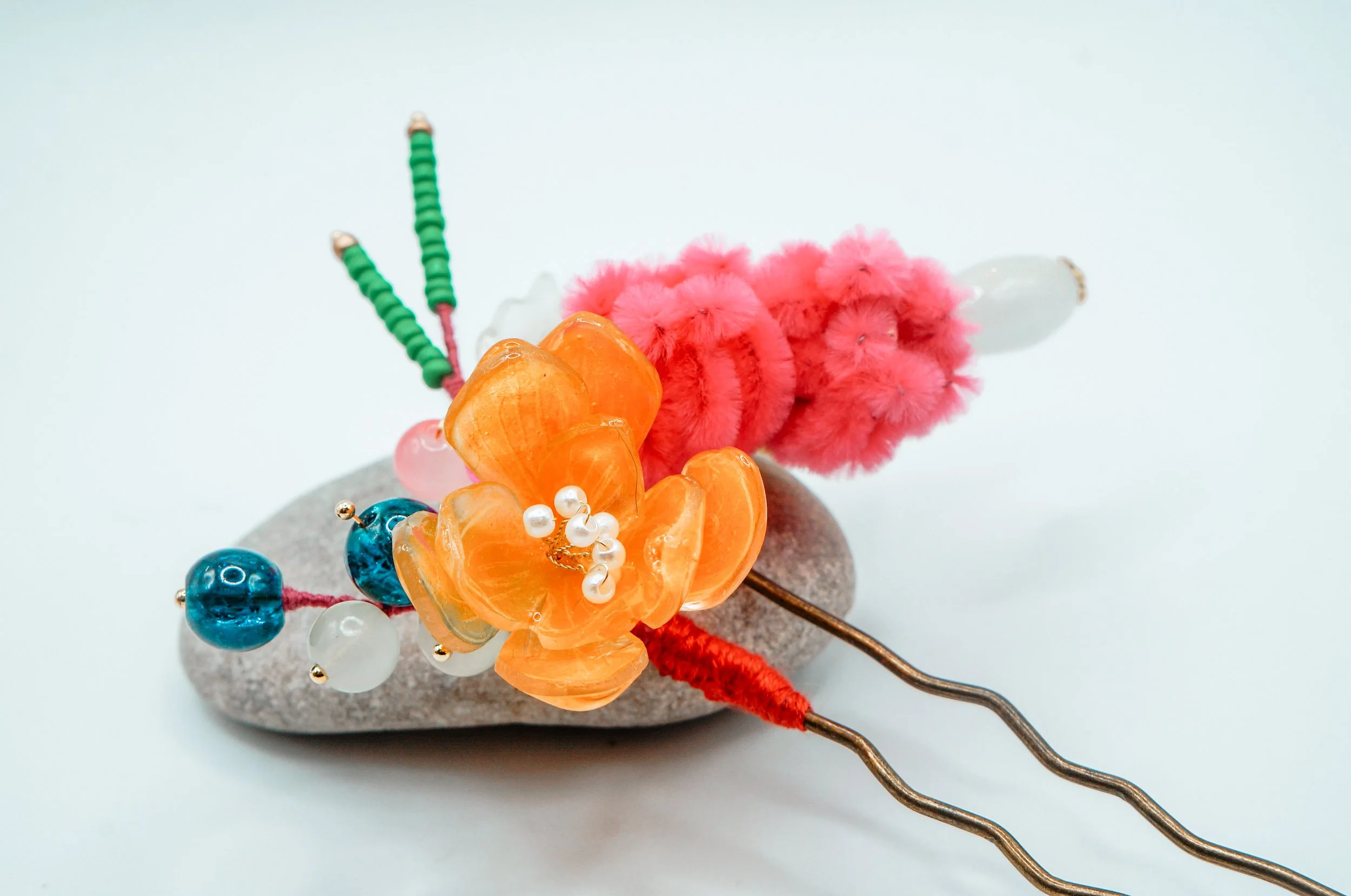 A handmade chinese hairstick with srink plastic flower, silk thread flower buds, and galss beads