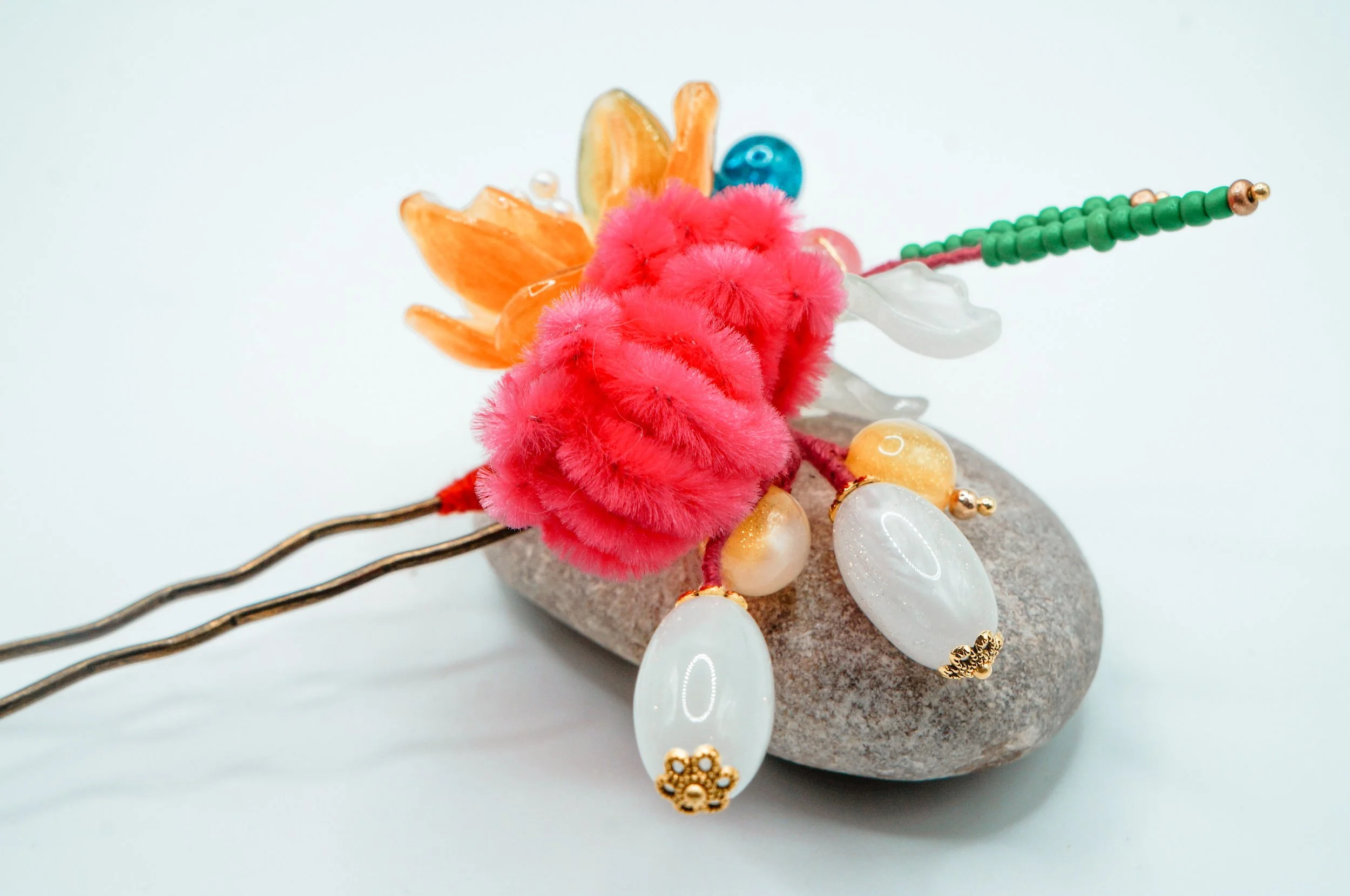 red-pink silk thread flower buds with UV-activated beads