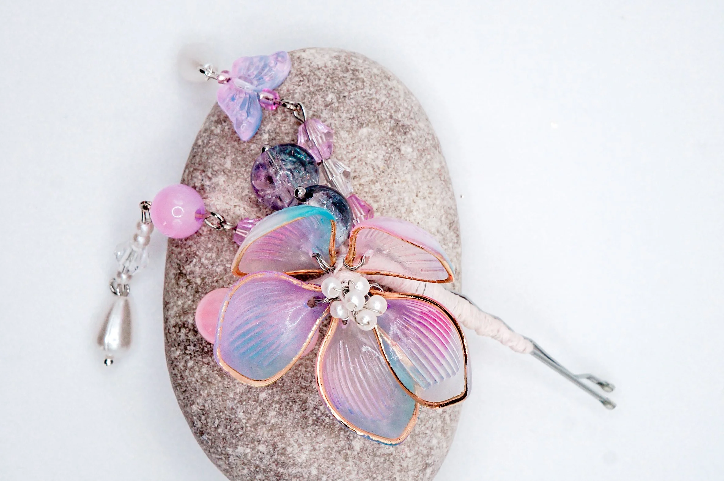 Hand crafted cherry blossom bobby pins with glass and natural stone beads and tassels featuring pink, blue, purple color hues